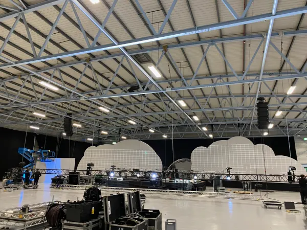 Before doors at SaaStock Europe 2022 — view of the Mainstage cloud-LED set from the rear of the empty Dublin venue, full lighting truss above and yet-to-be-set chairs at front