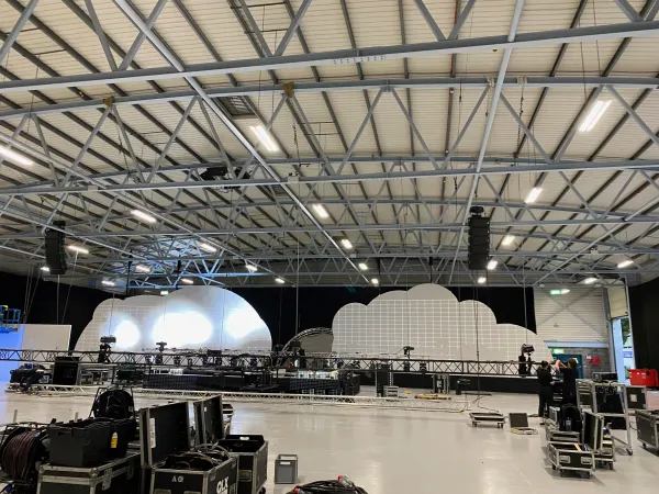 Before doors at SaaStock Europe 2022 — the SaaStock Dublin Mainstage cloud-shaped LED set fully assembled but unlit on an empty venue floor, modular truss runways still in foreground