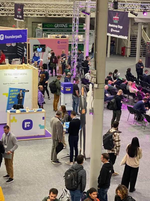Live during SaaStock Europe 2023 — elevated overview of the expo floor with attendees walking between the Founderpath, Mean Greens food court, Formaloo and Bootstrap Stage during the show