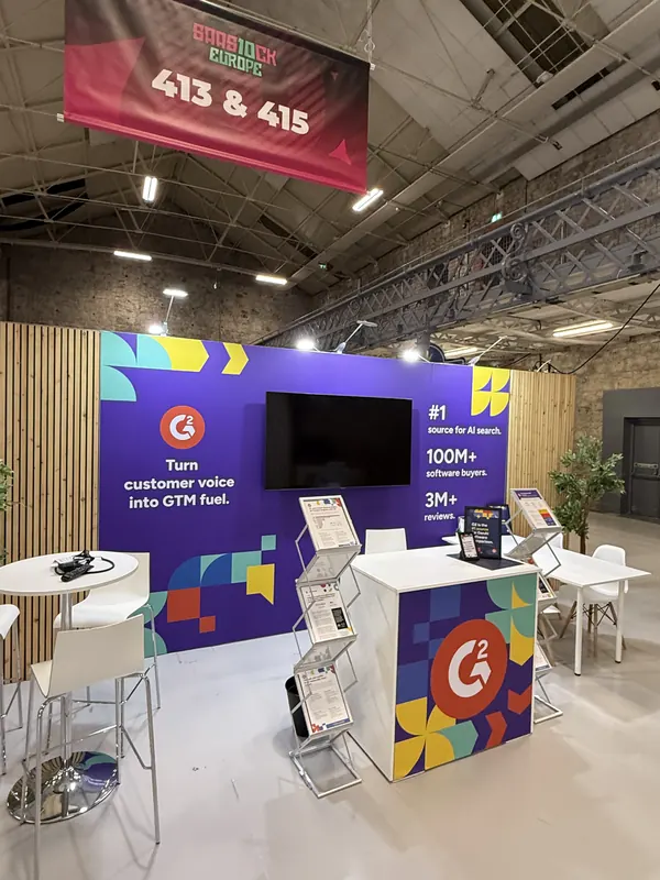 Before doors at SaaStock Europe 2025 — G2 booth 413 & 415 with 'Turn customer voice into GTM fuel' wall and '#1 source for AI search · 100M+ software buyers · 3M+' messaging