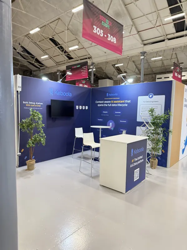 Before doors at SaaStock Europe 2025 — Keboola booth at 305–308 with 'Context-aware AI assistant that spans the full data lifecycle' messaging