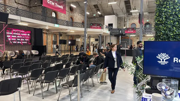 Live during SaaStock Europe 2025 — 16:9 wide shot of the GTM Track stage and seating area, Reditus booth visible at the right edge