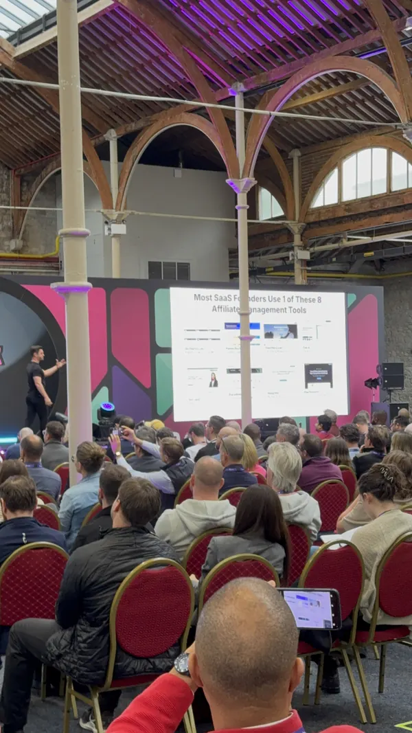 Live during SaaStock Europe 2025 — Founderpath on stage with 'Most SaaS Founders Use 1 of These 8 Affiliate-Management Tools' slide projected on the mainstage screen