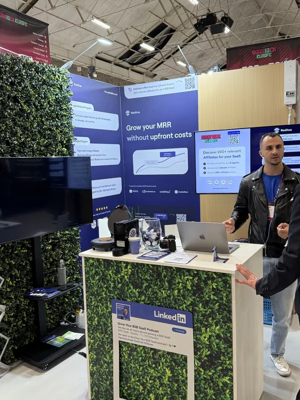 Live during SaaStock Europe 2025 — wide view of the GTM Track stage at the RDS Dublin with a band performing in front of a seated SaaS audience, GTM Track signage on the mezzanine