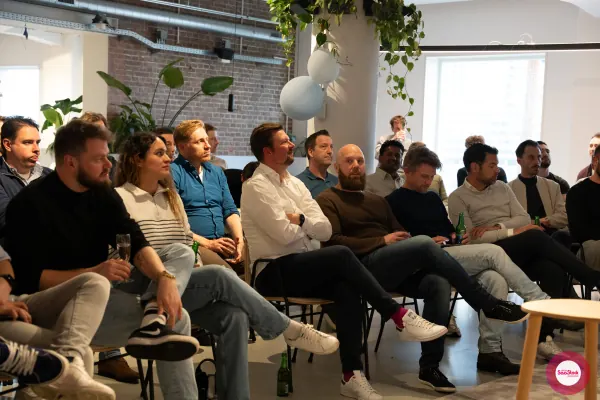 Live at SaaStock Local Amsterdam Q2 2024 — close-up of the audience watching a talk, seated in chairs at Personio's Amsterdam office
