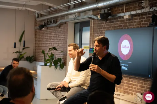 Live at SaaStock Local Amsterdam Q2 2024 — Koen Stam and the Lepaya co-founder laughing on stage during a relaxed beat in the Lepaya segment