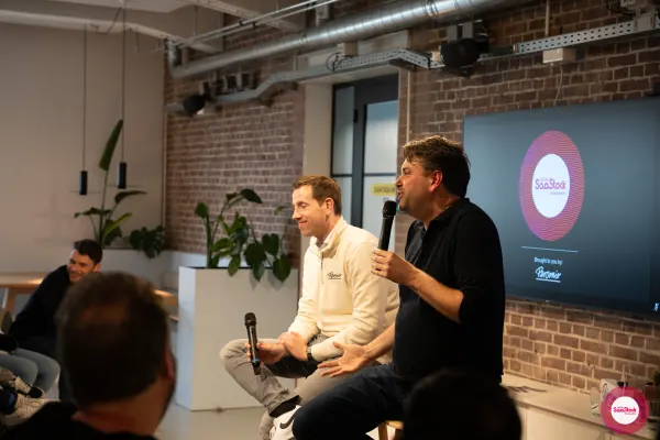 Live at SaaStock Local Amsterdam Q2 2024 — both speakers smiling on stage during the Lepaya × Personio segment