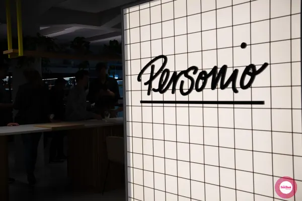 Personio's illuminated wordmark wall at the SaaStock Local Amsterdam Q2 2024 venue